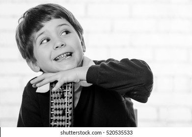 Portrait of primary school boy using abacus.