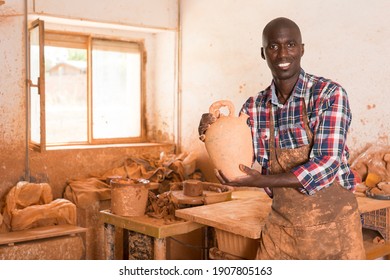 Portrait Of Professional African American Male Potter Standing In Pottery Workshop