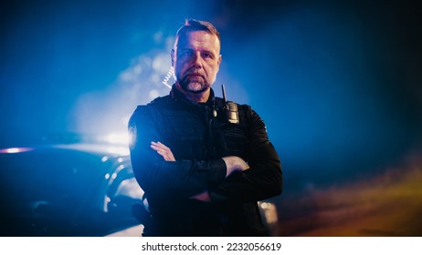 Portrait of Professional Caucasian Male Police Officer Crossing His Arms, Posing, Looking at the Camera. Heroic Officer of the Law on Duty, Keeping Citizens and Civilians Safe, Fighting Crime