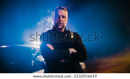 Portrait of Professional Caucasian Male Police Officer Crossing His Arms, Posing, Looking at the Camera. Heroic Officer of the Law on Duty, Keeping Citizens and Civilians Safe, Fighting Crime