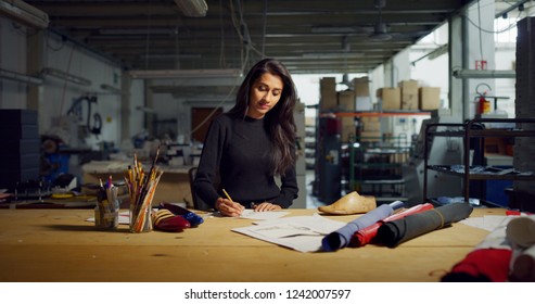 Portrait of professional fashion designer drawing a new shoe model according to the Italian tradition. Concept: fashion, design, mode, style - Shutterstock ID 1242007597