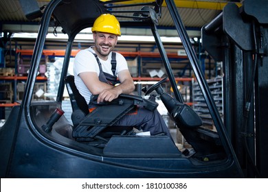 Portrait Of Professional Forklift Driver In Factory's Warehouse.