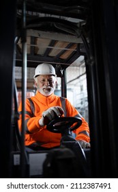 Portrait Of Professional Forklift Driver In Factory's Warehouse.