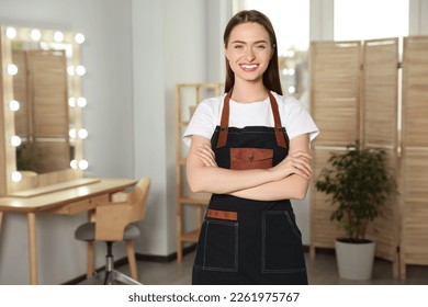 Portrait of professional hairdresser wearing apron in beauty salon - Powered by Shutterstock