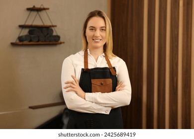 Portrait of professional hairdresser wearing apron in beauty salon - Powered by Shutterstock