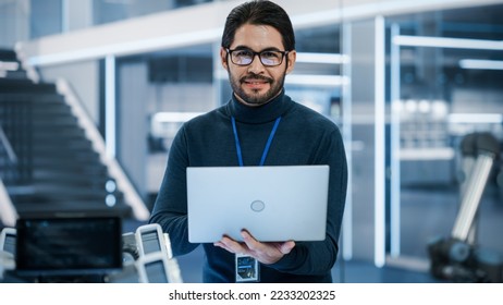 Portrait of a Professional Hispanic Man Using Laptop at Work in Research and Development Agency. Young Multiethnic Male Engineer, Developer or Scientist Working in Development Technology Office. - Powered by Shutterstock - Get 15% off with code: PIKWIZARD15