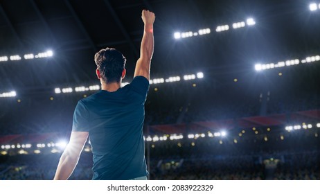 Portrait of Professional Male Athlete Happily Celebrating New Record for Winning Sport Championship. Determined Successful Sportsman Raising Arms Cheering for Gold Medal Victory. Shot on Large Stadium - Powered by Shutterstock