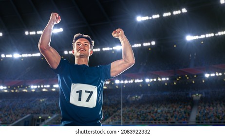 Portrait of Professional Male Athlete Happily Celebrating New Record for Winning Sport Championship. Determined Successful Sportsman Raising Arms Cheering for Gold Medal Victory. Shot on Large Stadium - Powered by Shutterstock