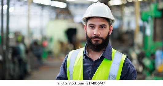 Portrait Professional mechanical engineering hispanic male in white safety hard hat helmet and look at camera at metal factory. - Shutterstock ID 2174856447