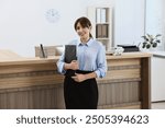 Portrait of professional receptionist in modern office