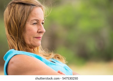 Portrait Profile Attractive Mature Woman, Sad, Thoughtful, Depressed, Sitting Lonely Outdoor, Blurred Background, Copy Space.