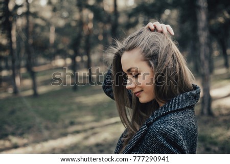 Portrait of profile woman straighten hair and looking down