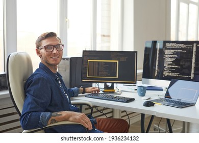 Portrait Of IT Programmer Using Computers With Code On Screen