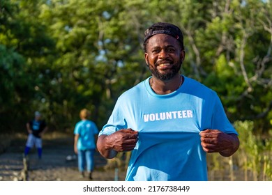 Portrait Of Proud African American Volunteer Man Enjoy Charitable Social Work Outdoor In The Mangrove Planting Project