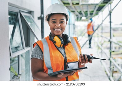 Portrait of proud black construction worker leading with power while managing site logistics on tablet. Happy female engineer supervising a building project and inspection of architectural details - Shutterstock ID 2190938193