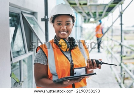 Portrait of proud black construction worker leading with power while managing site logistics on tablet. Happy female engineer supervising a building project and inspection of architectural details