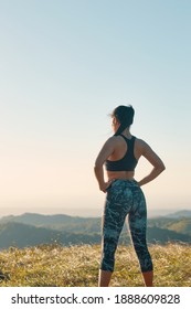 A Portrait Of Proud Woman In Sporty Clothes With Her Hands On Hips Standing After Exercising