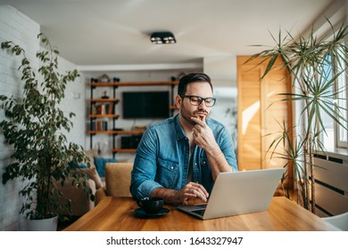 Portrait of a puzzled man looking at laptop at modern home. - Shutterstock ID 1643327947