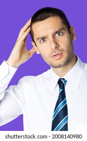 Portrait Of Puzzled Shocked Young Brunette Businessman In White Shirt And Tie Isolated Over Violet Purple Colour Background With Copy Space Area. Confident Business Man At Studio Image. Male Executive