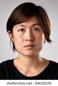 Portrait of real chinese asian woman with no expression ID or passport photo full collection of diverse face and expressions