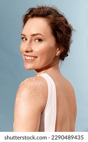 Portrait of real smiling woman  with white scrub on the shoulder 