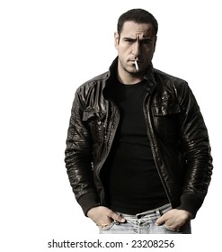 Portrait of a rebel type guy in classic leather jacket with cigarette in mouth against white background