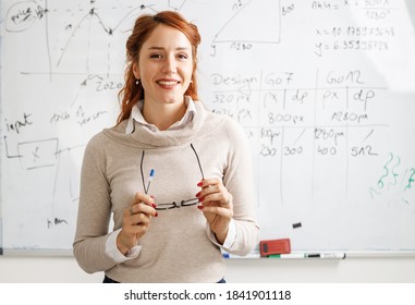 Portrait of red hair female professor. She lecture about  new technologies and software development. - Shutterstock ID 1841901118