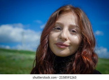 A portrait of a red haired Armenian girl in the field