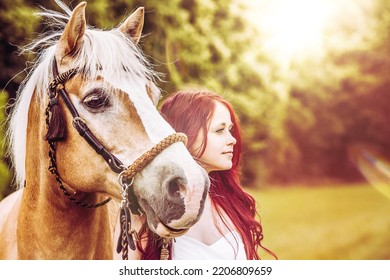 Portrait Of Red Haired Woman With Brown Horse In The Sunset Backlight With Lens Flare