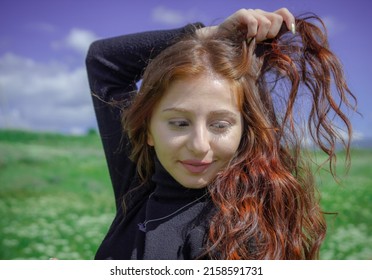 A portrait of a red-haired Armenian girl in the field