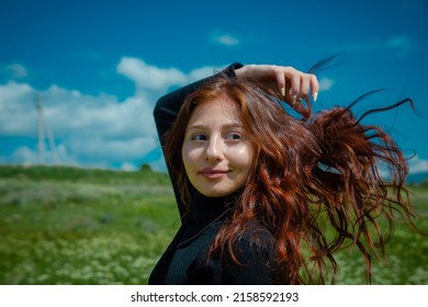A portrait of a red-haired Armenian girl in the field