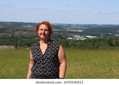 Portrait of a red-haired woman with glasses in the park - Powered by Shutterstock