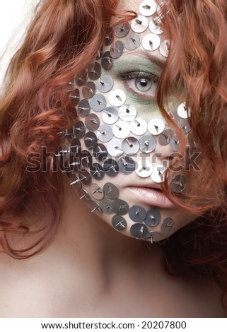 portrait of a red-hairl woman with drawing pin on her face