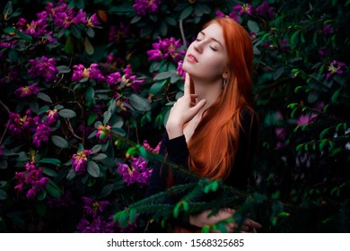 Portrait of redhead girl with flowers