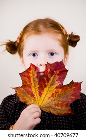 Portrait of redhead girl over background with maple leave