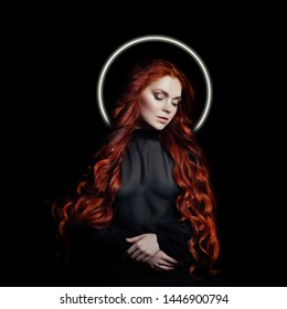 Portrait of redhead sexy woman with long hair halo nimbus over her head on black background. Perfect girl with nimb, blue eyes, nice clean skin, beautiful natural makeup, red hair, saint madonna