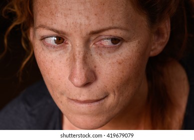 Portrait of redhead woman anxiety expression with tears in eyes trying not to cry suppressed emotion