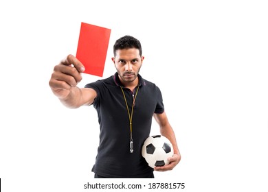 Portrait Of Referee Holding Ball And Red Card