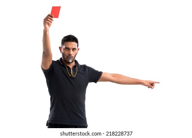 Portrait Of Referee Whistling And Showing Red Card