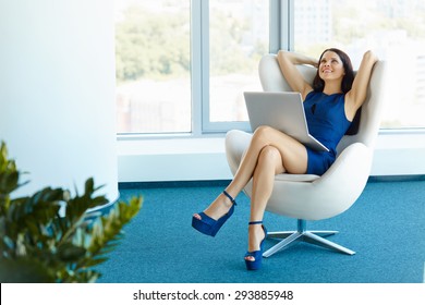 Portrait Of Relaxed Business Woman In Office. Relax And Freedom Concept
