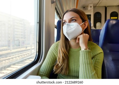 Portrait Of Relaxed Female Commuter Wearing Medical Protective Mask Looking Through The Window Sitting On Train