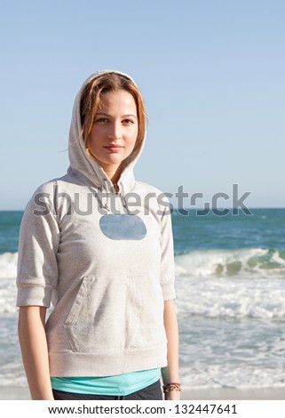 Similar – Woman walking on a beach on a cloudy day