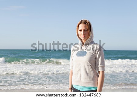 Similar – Woman walking on a beach on a cloudy day