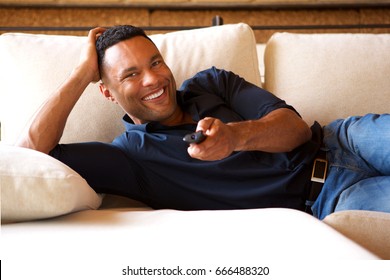 Portrait Of Relaxed Young Black Man Watching Tv At Home