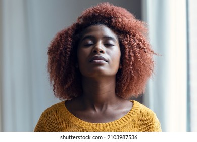 Portrait Of Relaxing Woman Looking Up While Relaxes Taking A Deep Breath Standing In The Living Room At Home.