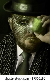 Portrait of reptilian man in expensive clothing holding a green apple