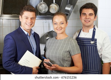 Portrait Of Restaurant Team Standing In Kitchen