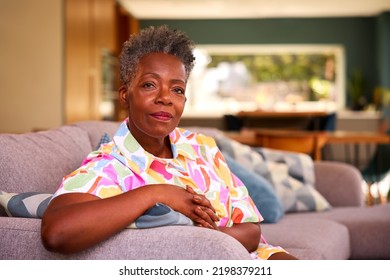 Portrait Of Retired Serious Senior Woman Sitting On Sofa At Home - Powered by Shutterstock