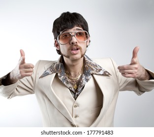 Portrait Of A Retro Man In A 1970s Leisure Suit And Sunglasses Pointing To The Camera 