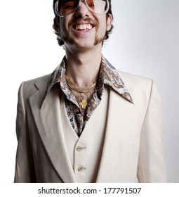 Portrait Of A Retro Man With A Gold Tooth In A 1970s Leisure Suit And Sunglasses Smiling To The Camera 